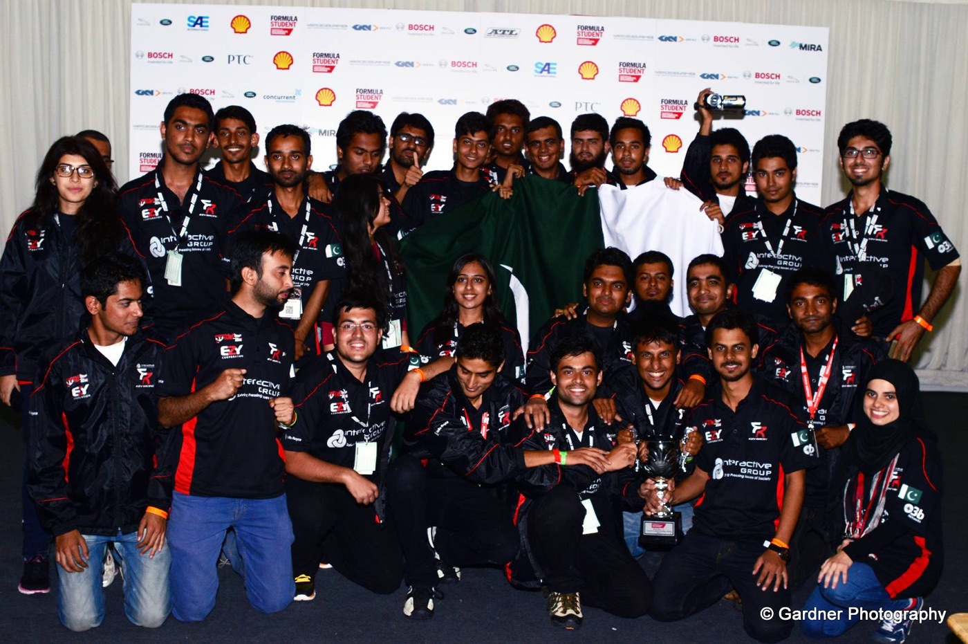 NUST Formula Student team celebrating an award