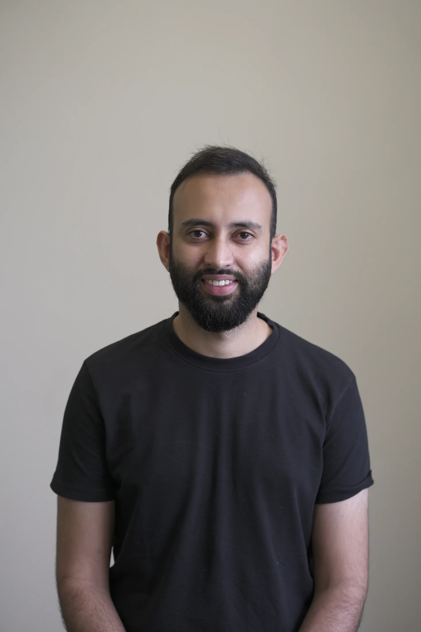 Shah Talha Sohail, in a black shirt, looking toward the camera
