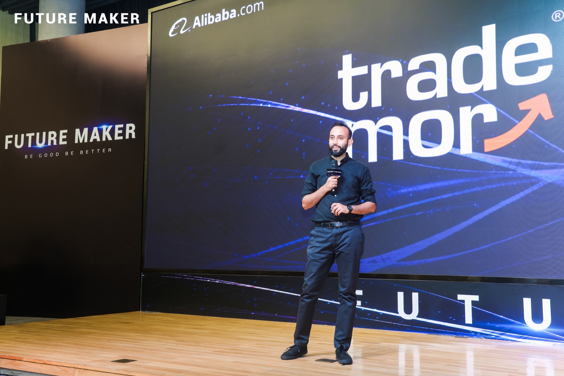 Shah Talha speaking at an event with Trademor on stage